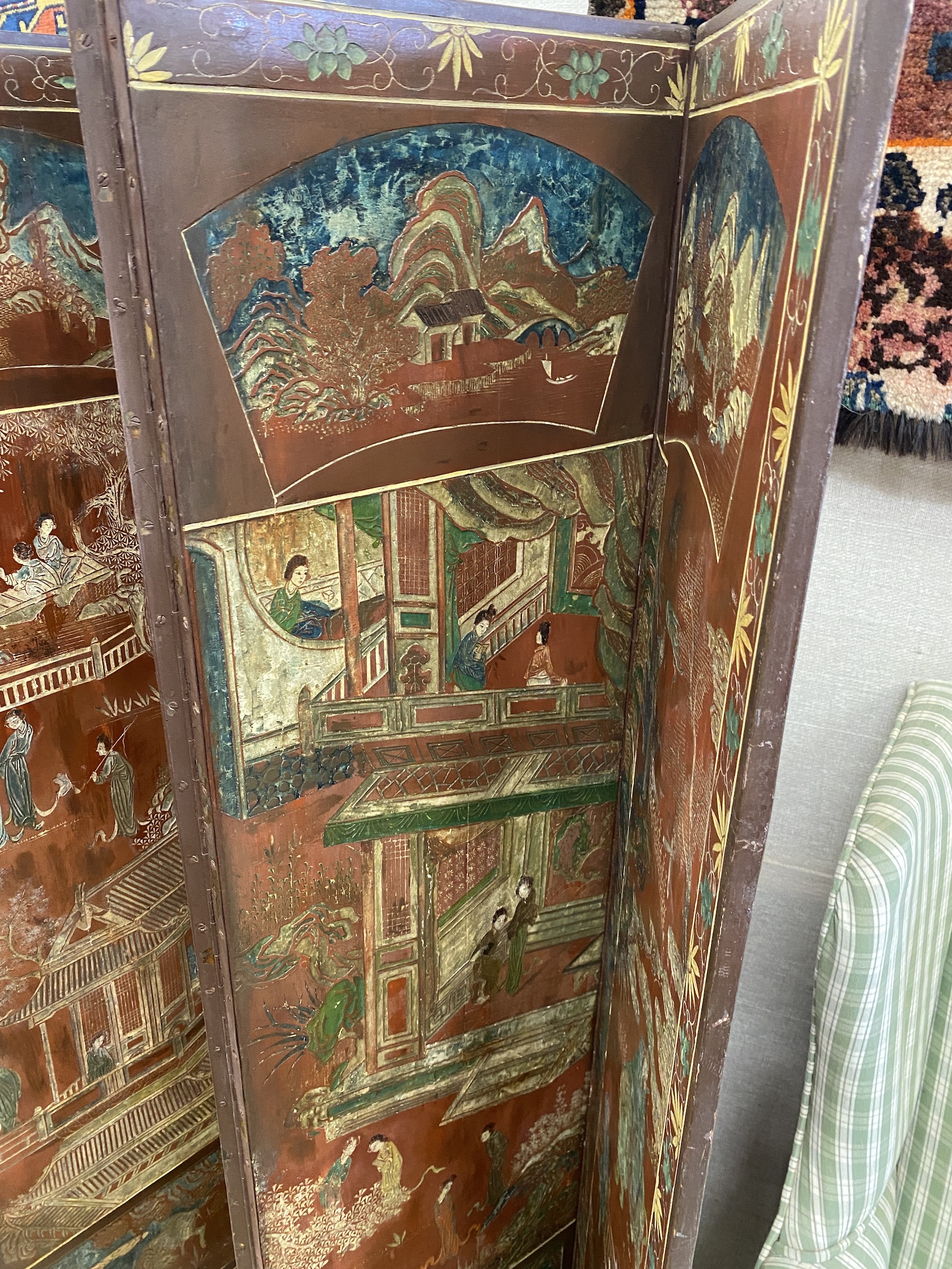 A Chinese lacquer eight fold dressing screen, each panel width 38cm, height 160cm
